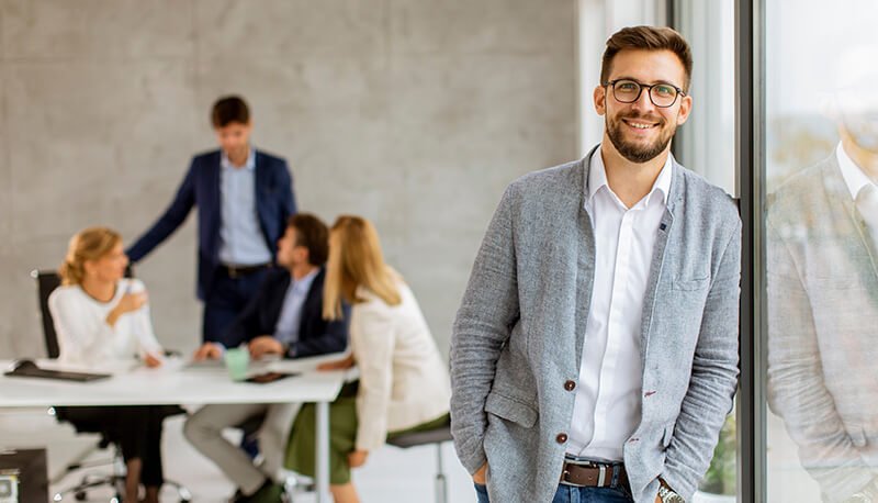 Handsome young business man standing confident in the office